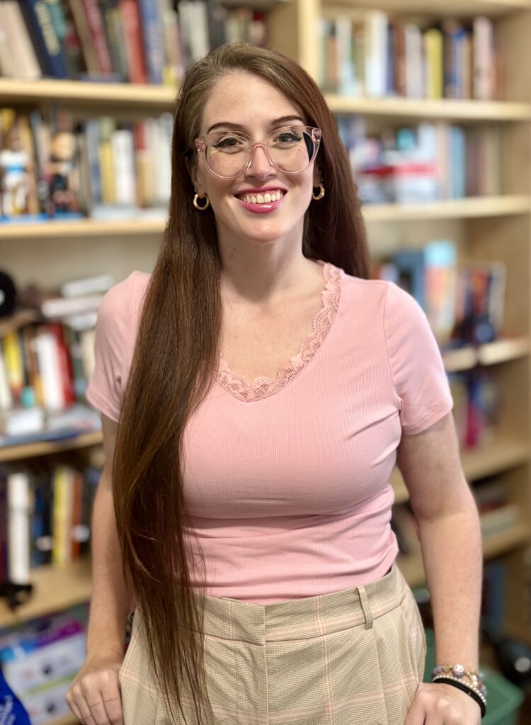 Katherine Widner's headshot inside of a library.