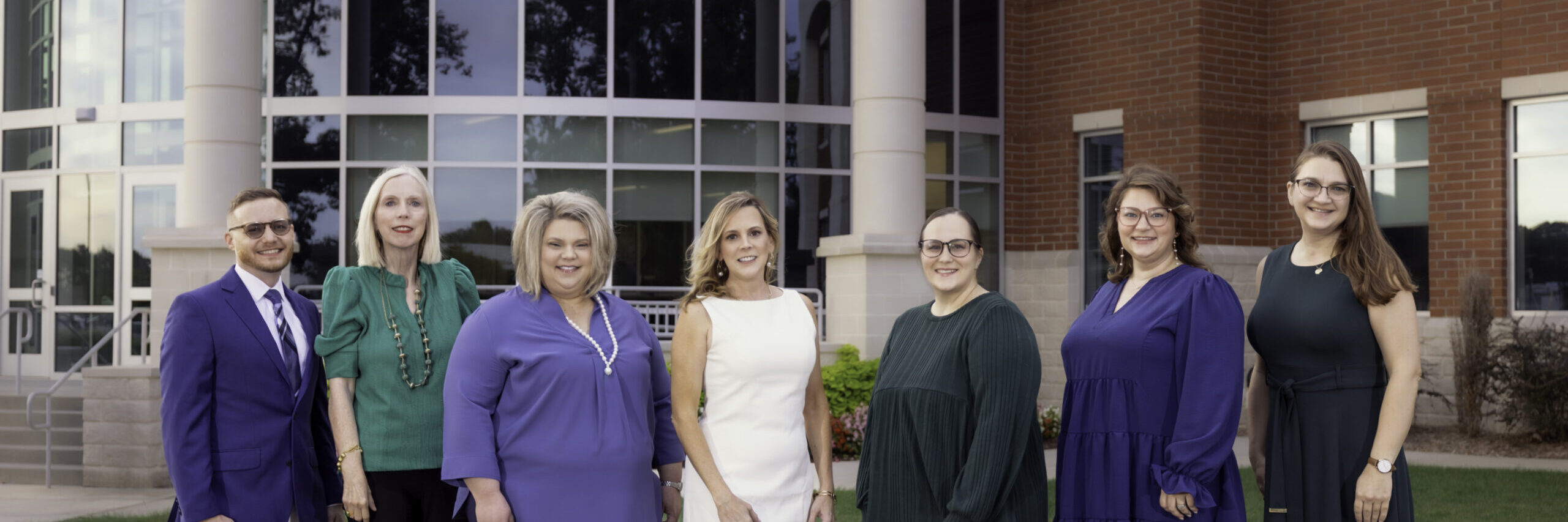 Foundation team members standing together in front of OCH campus.